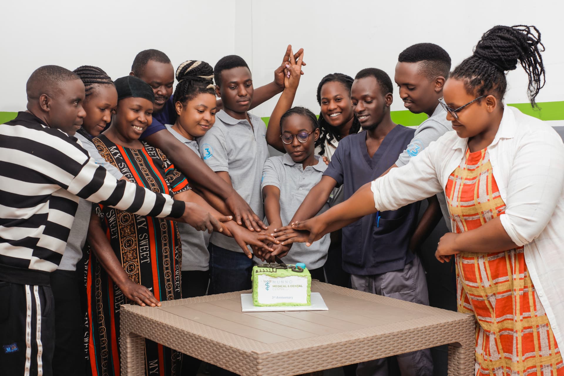 Munno Health team sharing a cake-cutting celebration